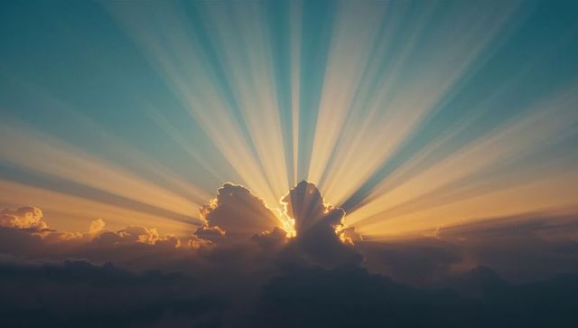 Radiant Sunbeams Piercing Atmospheric Cumulus Clouds at Sunset