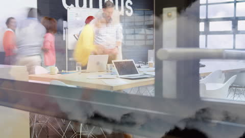 Diverse Team Collaborating in Modern Office with Cloud Overlay