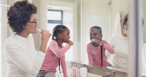 Mother and Daughter Practicing Tooth Brushing Together