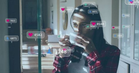 Woman Sipping Coffee with Social Media Icons in Cozy Kitchen