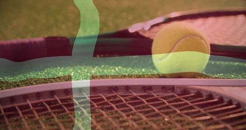 Tennis equipment on artificial turf in sunlight