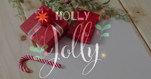Holly Jolly Christmas Gifts and Candy Cane on Wooden Background - Download Free Stock Images Pikwizard.com
