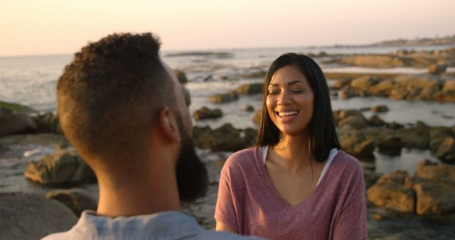 Happy Couple Smiling on Rocky Beach During Sunset - Download Free Stock Images Pikwizard.com