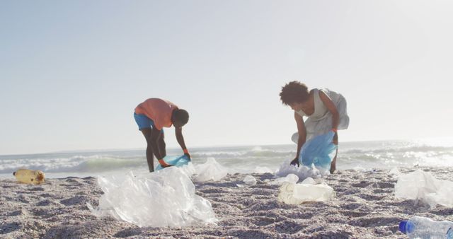 Children are picking up plastic waste on a sandy beach with the ocean in the background. The scene depicts environmental responsibility, teamwork, and community involvement. Suitable for use in topics related to pollution, ocean cleanliness, environmental campaigns, and sustainability movements.