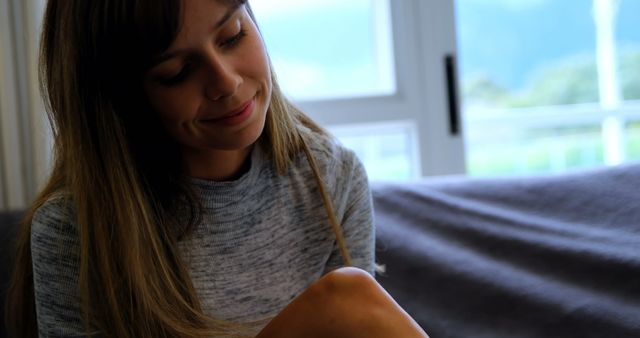 Smiling Woman with Light Brown Hair Relaxed at Home Near Window - Download Free Stock Images Pikwizard.com