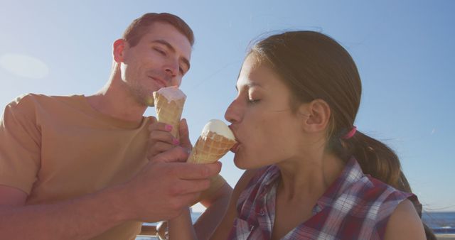 Young Couple Enjoying Ice Cream on Sunny Day Outdoors - Download Free Stock Images Pikwizard.com