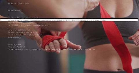 Female athlete wrapping hands with red boxing wraps, code overlay blending fitness and technology