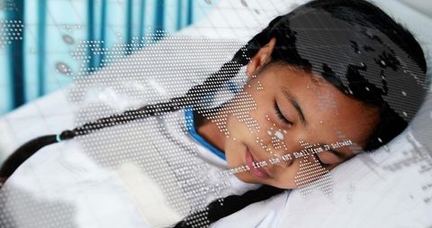 Schoolgirl sleeping in hospital bed with digital world map overlay conveying healthcare data