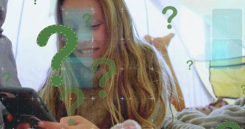 Young Woman Smiling while Using Smartphone in Bed Encircled by Digital Icons