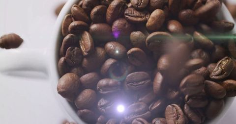 Falling Roasted Coffee Beans in White Mug with Flare