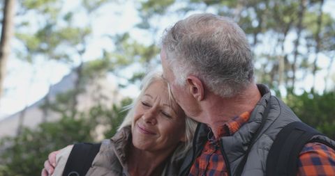 Happy Senior Couple Embracing in Sunny Mountain Forest - Download Free Stock Images Pikwizard.com