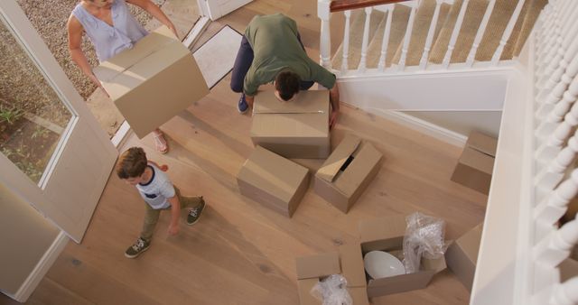 Family Moving into New Home with Cardboard Boxes and Household Items - Download Free Stock Images Pikwizard.com