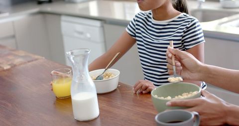 Mother and Daughter Dining breakfast together At Home
