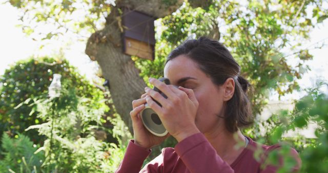 Woman Enjoying Coffee Outdoors in Lush Green Garden - Download Free Stock Images Pikwizard.com