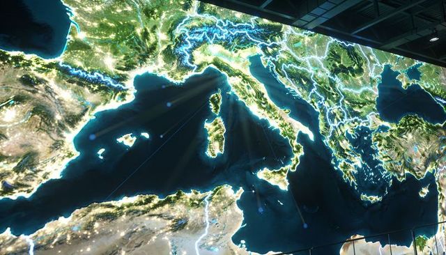 Illuminated central mediterranean led map display showing maritime routes and neon borders