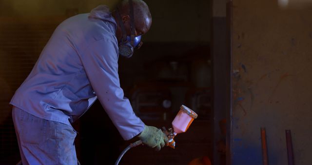 Worker Begins Spray Painting Metal Surface in Workshop - Download Free Stock Images Pikwizard.com