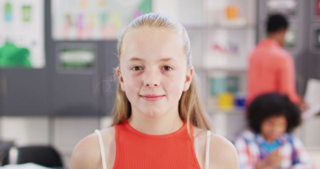 Confident Schoolgirl Posing in Colorful Classroom - Download Free Stock Images Pikwizard.com