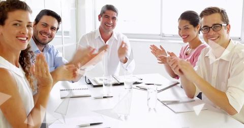 Diverse Professionals Applauding Collaboration Success at Office Meeting