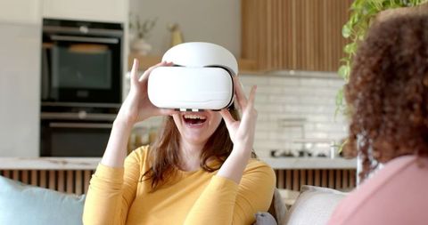 Friends Enjoying Virtual Reality Together in Cozy Living Room
