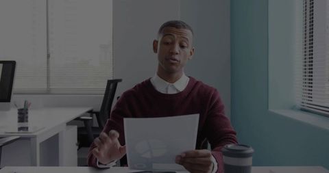 Smart Business Professional Analyzing Financial Documents in Modern Office