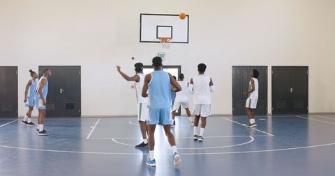 Basketball Players Practicing Drills in Indoor Gymnasium