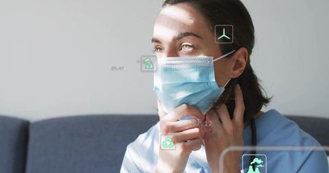 Nurse contemplating while wearing surgical mask and stethoscope with AR icons in sunlight