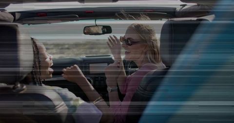 Friends Enjoying Road Trip in Convertible Desert Adventure