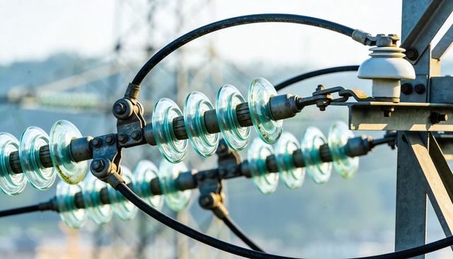 High-voltage glass disc insulators on transmission line with ceramic bushing