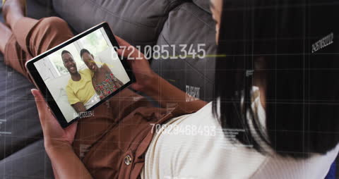 Woman Engaging in Video Call on Tablet with Data Overlays