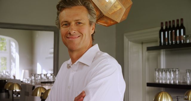 Confident Middle-aged Man Standing in Stylish Modern Kitchen - Download Free Stock Images Pikwizard.com