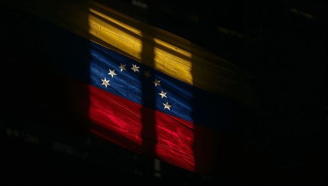Backlit venezuelan flag waving with dramatic blind shadows and textured fabric detail