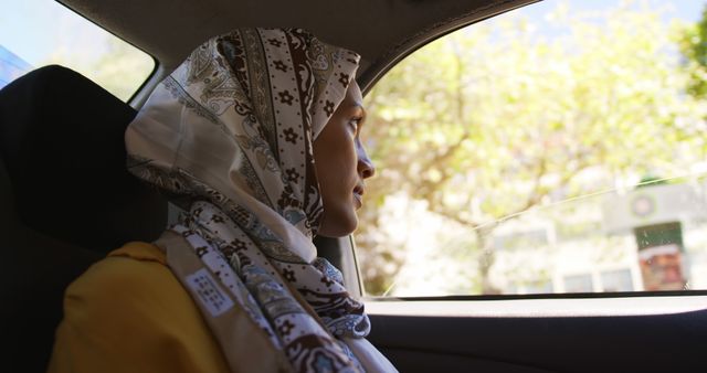 Woman with Hijab Looking Out Car Window - Download Free Stock Images Pikwizard.com