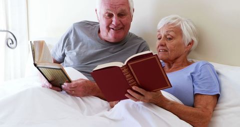 Happy Senior Couple Enjoying Books in Bedroom - Download Free Stock Images Pikwizard.com