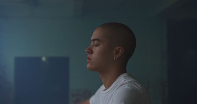 Serene Young Person Practicing Meditation in Dimly Lit Room - Download Free Stock Images Pikwizard.com