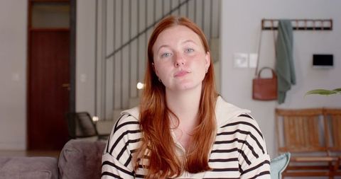 Woman Relaxing in Cozy, Modern Minimalist Living Room with Soft Elegance