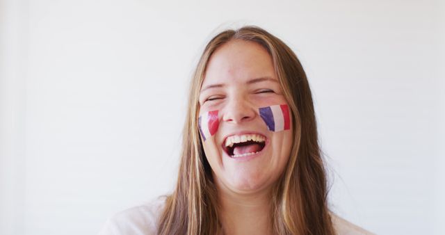Image of happy caucasian woman with flag of france cheering. Sport, cheering and patriotism concept.