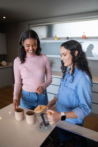 Happy Friends Making Coffee in Modern Kitchen