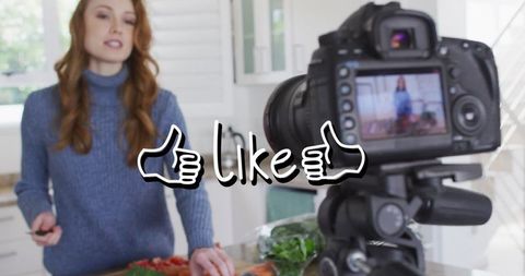 Caucasian woman filming cooking vlog in kitchen