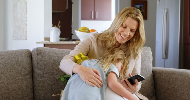 Loving Mother Hugging Daughter While Using Smartphone in Cozy Living Room - Download Free Stock Images Pikwizard.com