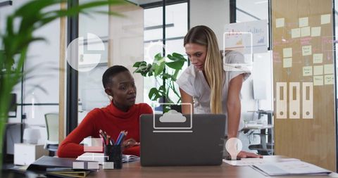 Diverse Colleagues Engaged in Financial Data Discussion at Modern Office