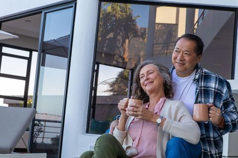 Diverse Senior Couple Enjoying Relaxation on Patio Balcony