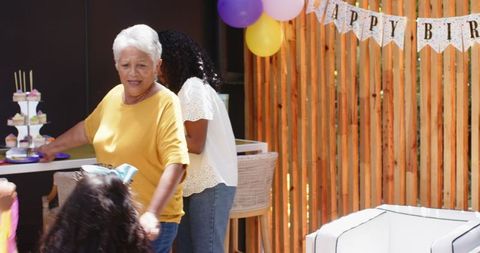 Multigenerational Family Preparing for Birthday Celebration at Home