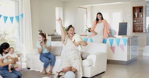 Cheerful Baby Shower with Diverse Friends Celebrating in Living Room