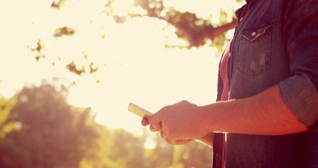 Person Using Smartphone Outdoors in Sunshine - Download Free Stock Images Pikwizard.com