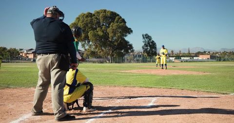 Youth Baseball Umpire Catcher Pitcher Preparing Pitch on Sunny Field