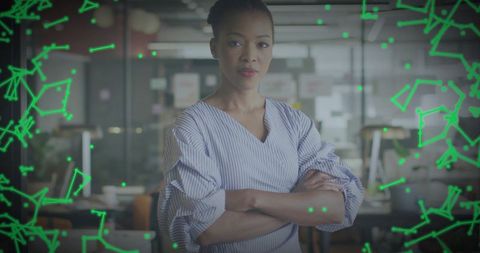 Confident businesswoman standing with arms crossed in modern office, neon network overlay