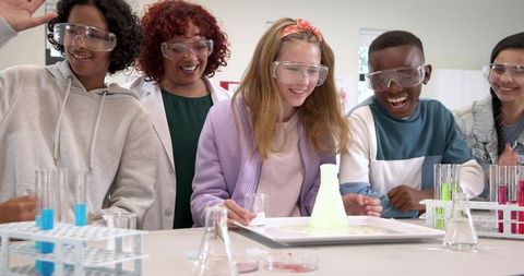 Diverse Students Conduct Science Experiment with Teacher in Lab