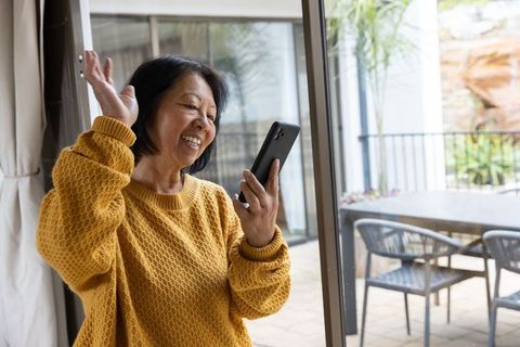 Cheerful Senior Woman Using Smartphone for Video Call