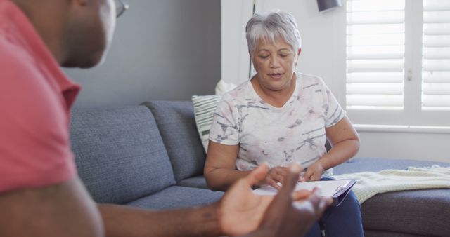 Elderly Woman Having Serious Conversation with Young Man at Home - Download Free Stock Images Pikwizard.com