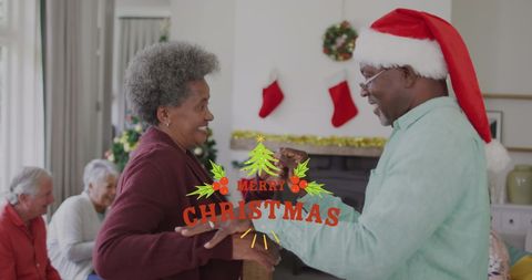 Smiling Senior Couple Dancing Together at Christmas Celebration